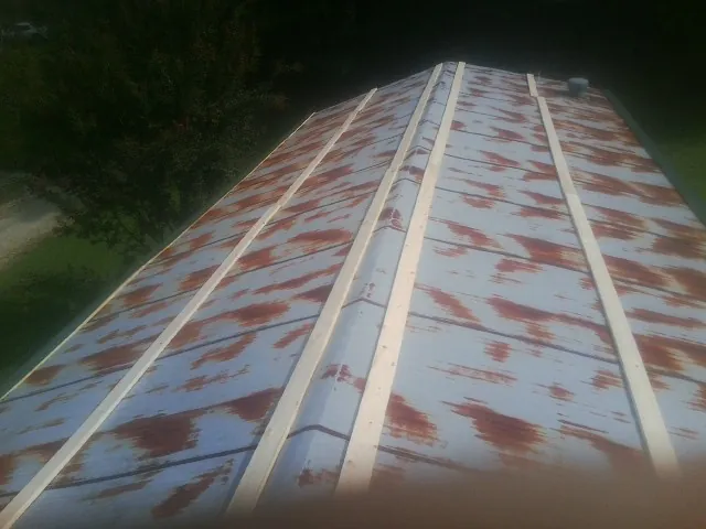 Rusted metal roof panels with new wood purlins before replacement — Storm Damage Roof Repair in Big Bar by Roofing Brothers